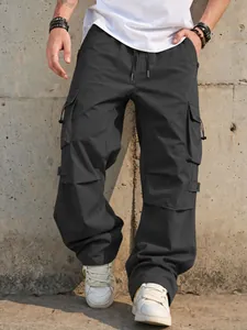 Detail showing texture and large functional pockets of dark grey parachute cargo pants