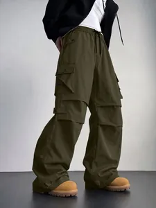 Dettaglio dei pantaloni cargo paracadute verde oliva con tasche multiple e gamba larga