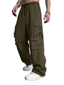 Loose fit men's olive green parachute cargo pants with multiple functional pockets