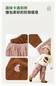 Close-up detail of children's soft corduroy trousers with cute pink cat embroidery design.