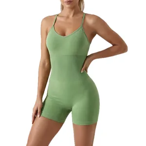 Professional one-piece green yoga jumpsuit with thin straps and ribbed waist detail