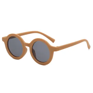 Close-up detail of children's retro round sunglasses featuring a matte ginger frame