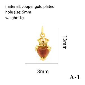 Detailed view of an 18K gold-plated heart pendant with crown design and measurements