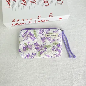 Small floral print canvas pouch with purple zipper and May Rabbit brand label