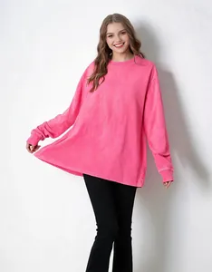 Detail view of pink washed cotton oversized sweatshirt showing fabric texture and fit