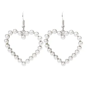 Elegant heart-shaped hollow earrings with white pearls and silver-tone frame for women