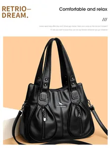 Detailed view of a black pebbled leather handbag with kangaroo logo and front zip pockets