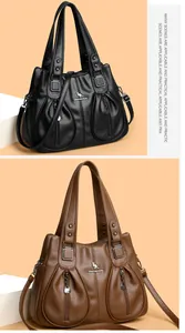 Detail of large capacity women's crossbody handbags in black and brown faux leather