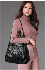 Elegant black faux leather large capacity handbag with kangaroo logo shown on model