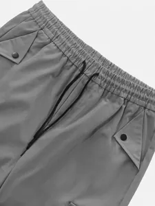 Close-up of men's quick-dry parachute cargo pants with elastic waist and drawstring
