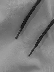 Detailed macro shot of grey twill fabric texture and black drawstring on mens cargo pants