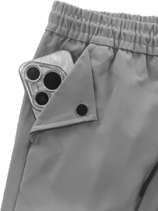 Close-up macro view showing the functional side pocket of grey techwear parachute pants