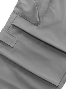 Detail view of flap pocket and durable quick-dry fabric on gray techwear cargo pants