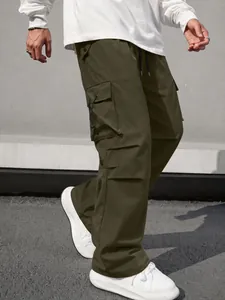 Detailed view of men's olive green tactical cargo pants featuring large side pockets