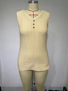 Front view of beige eyelet sleeveless top with decorative buttons on mannequin.
