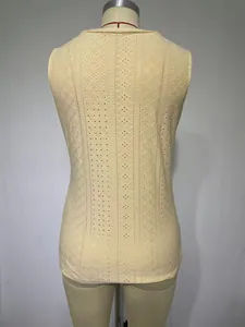 Back view of a casual beige sleeveless tank top featuring intricate eyelet lace embroidery