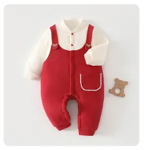 Detailed view of red and cream baby winter romper with cute pearl pocket and bows.