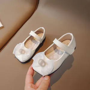 Elegant white patent leather girls' princess Mary Janes featuring a stylish tulle bow
