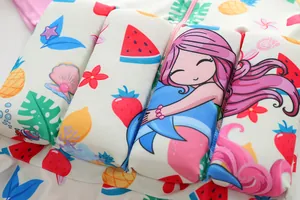 Close-up of children's buoyancy swimsuit featuring cute mermaid and fruit patterns