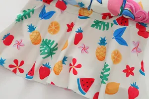 Detailed close-up view of colorful fruit print on white children's swimwear skirt