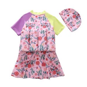 Detailed view of girls' pink floral buoyancy swimsuit set including matching swim cap
