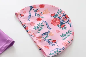 Close-up of pink children's swim cap with vibrant floral rose pattern