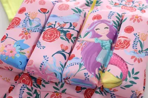 Close-up detail of mermaid and floral foam buoyancy panels on pink girls swimsuit