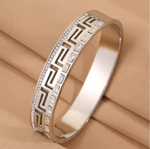 Luxury silver stainless steel bangle featuring Greek key pattern and clear crystal inlay