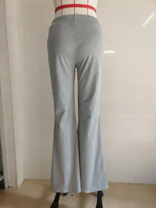 Close-up rear view of grey high-waisted flared yoga pants on a mannequin display