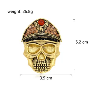 Detailed view of golden skull brooch with rhinestones, 5.2x3.9cm size, 26.8g weight.
