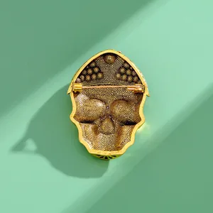 Back view of gold-toned alloy Halloween skull brooch showing the pin fastener detail