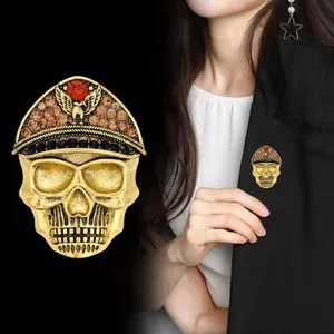 Close-up of Halloween skull brooch with eagle hat and rhinestones on black blazer