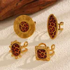 Detailed view of vintage gold leopard print rings in various shapes on textured background.
