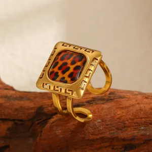Detailed macro view of a vintage gold square ring with leopard print inlay and geometric patterns