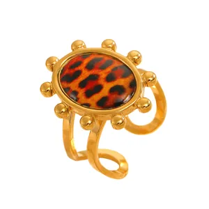 Detail view of a vintage gold-toned ring with an oval leopard print stone inlay