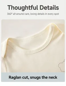 Close-up detail of raglan sleeve neckline on soft cream cotton baby bodysuit for infants