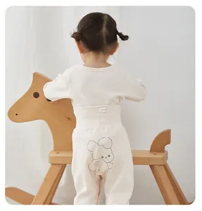 Back view of toddler cotton loungewear set featuring a cute cartoon bunny print on pants