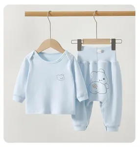 Detail of baby long-sleeved thermal set in light blue with cute cartoon bear print.