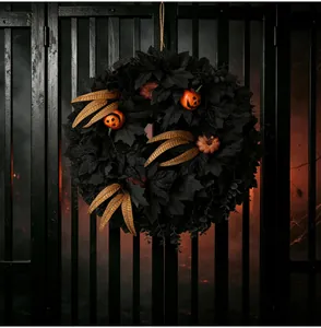 Detail of black maple leaf Halloween wreath with orange pumpkins on a dark gate
