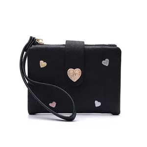 Close-up of black leather wallet with heart embroidery and functional wrist strap