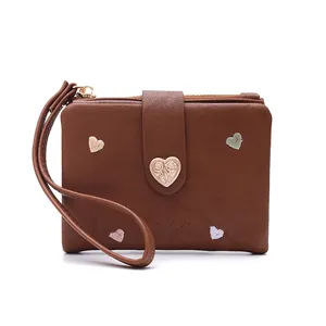 Detailed view of brown women's wallet with colorful heart embroidery and rose buckle