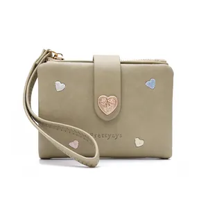 Detailed view of sage green folded wallet with heart embroidery and heart buckle