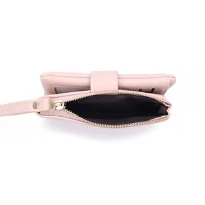 Interior detail of a pale pink women's short wallet showing the open zipper pocket.