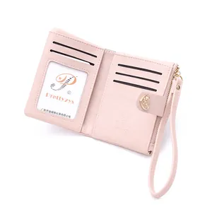 Detailed interior view of a pink short fold wallet with heart buckle and wrist strap