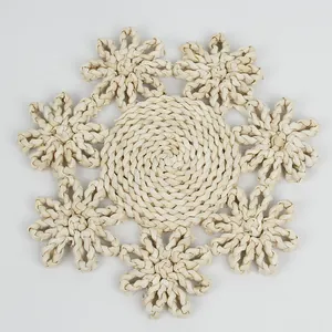 Detailed view of a handmade flower-shaped straw woven placemat with natural texture