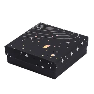 Elegant black starry sky jewelry gift box with iridescent silver foil celestial patterns.