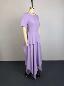 Side view showing the tiered peplum waist and asymmetrical hem of a lavender dress