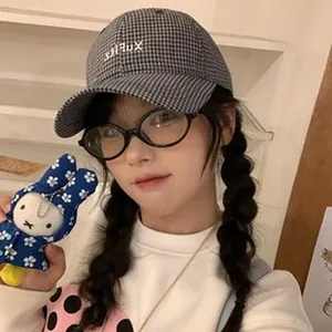 Asian model wearing retro black and white checkered baseball cap in a lifestyle setting