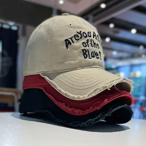 Stacked vintage washed denim baseball caps featuring unique distressed frayed brim details