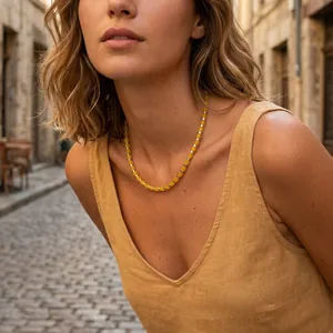 Vista dettagliata di una modella con collana di perline in tubi di pietre dure gialle.